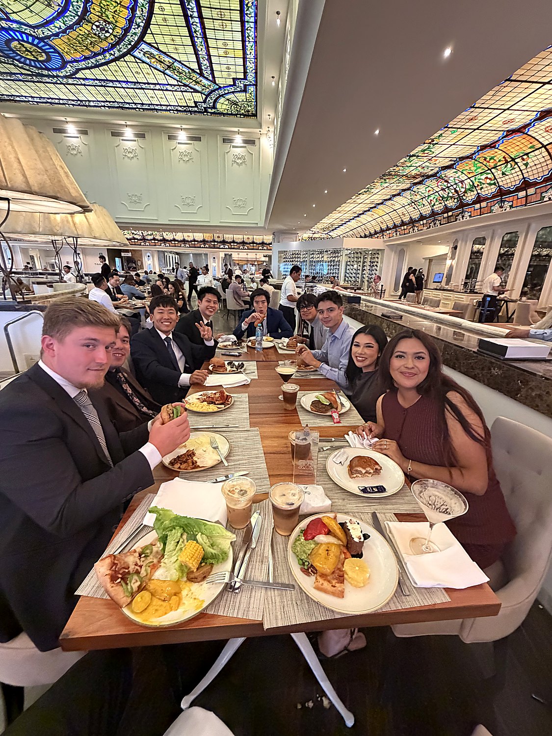 Team dinner in a restaurant with a stained-glass ceiling